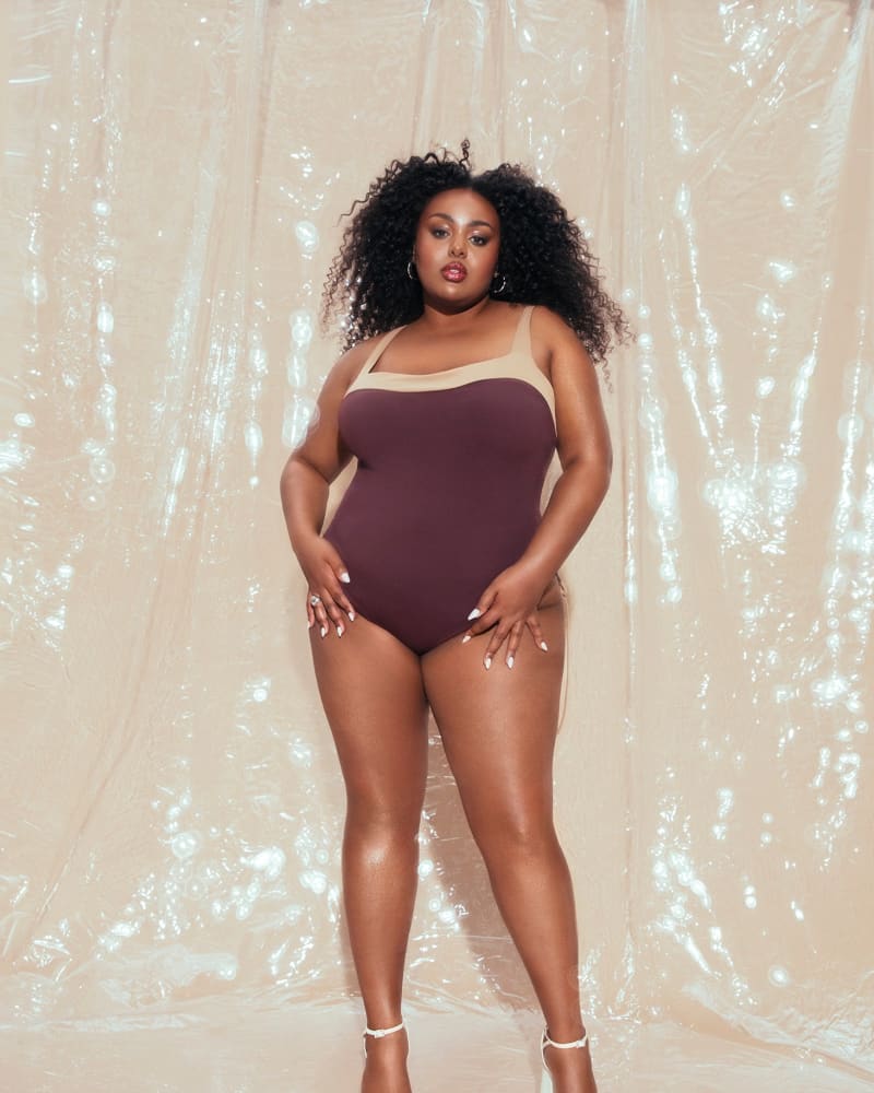 Front of a model wearing a size 1X Lace Up Back Swimsuit in Brown by Hilary MacMillan. | dia_product_style_image_id:297142